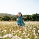 Funny kid girl in floral field outdoor
